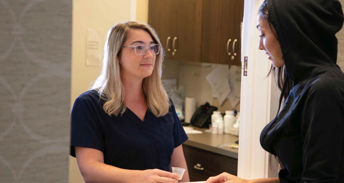 Two women engage in a profound discussion about the diverse drug and alcohol intervention methodologies, including the Johnson Model, Invitational Model, Systemic Family Model, ARISE Model, Motivational Interviewing, CRAFT, and the Field Model, showcasing their individual approaches to sobriety.